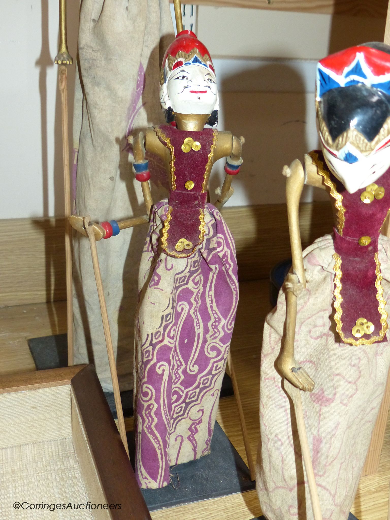 Three Indonesian stick puppets and another framed puppet, tallest 59cm
